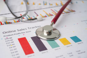 A stethoscope placed on an online sales tracker report, symbolizing the importance of diagnosing and improving sales pipeline health.